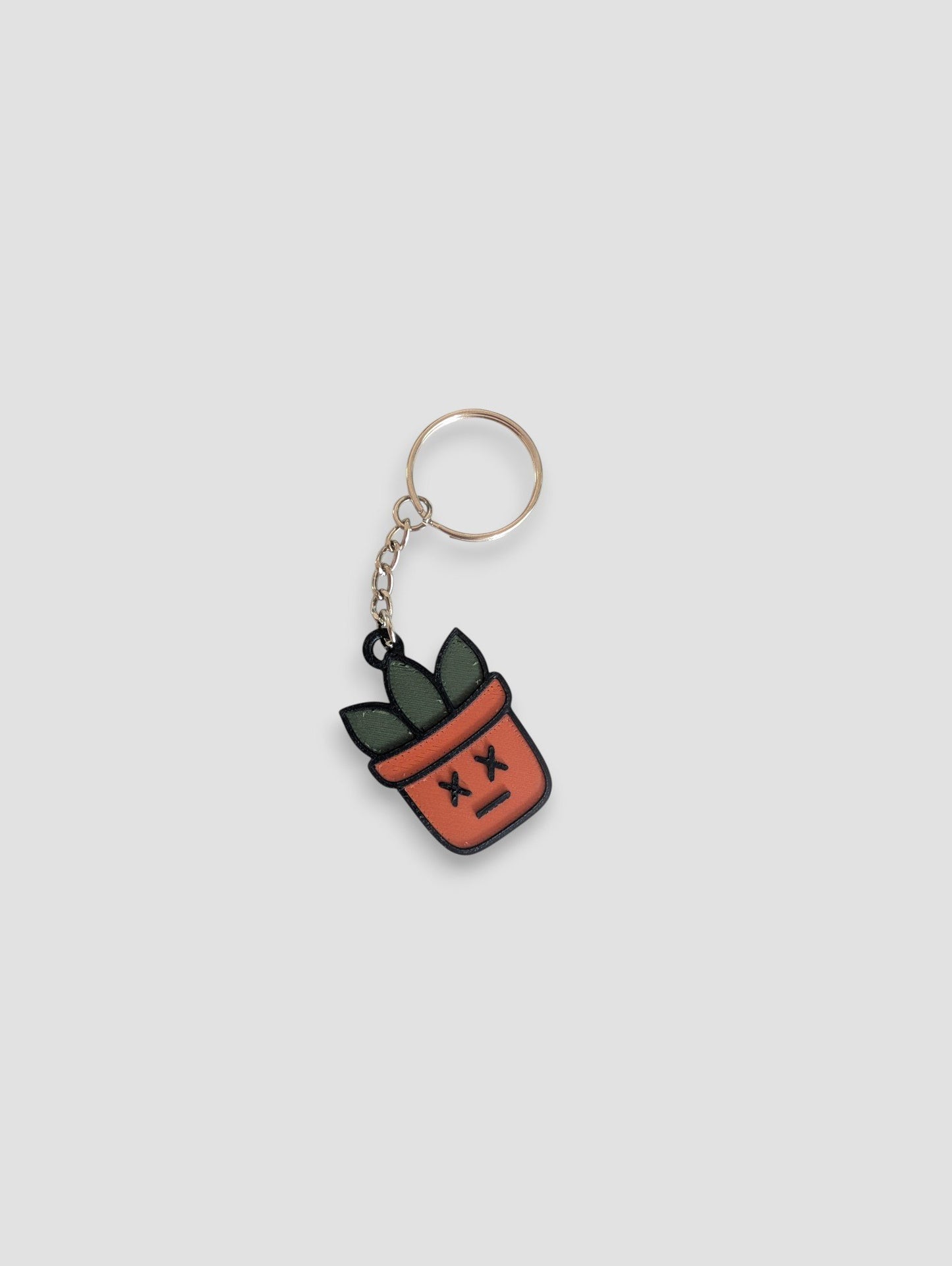63fe71384f2da238419a4f9e_dead-face-plantmoji-keychain_1753360509623.jpg