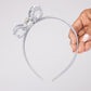 63fe71384f2da238419a4f9e_silver-girls-bow-headband_1788456350839.jpg