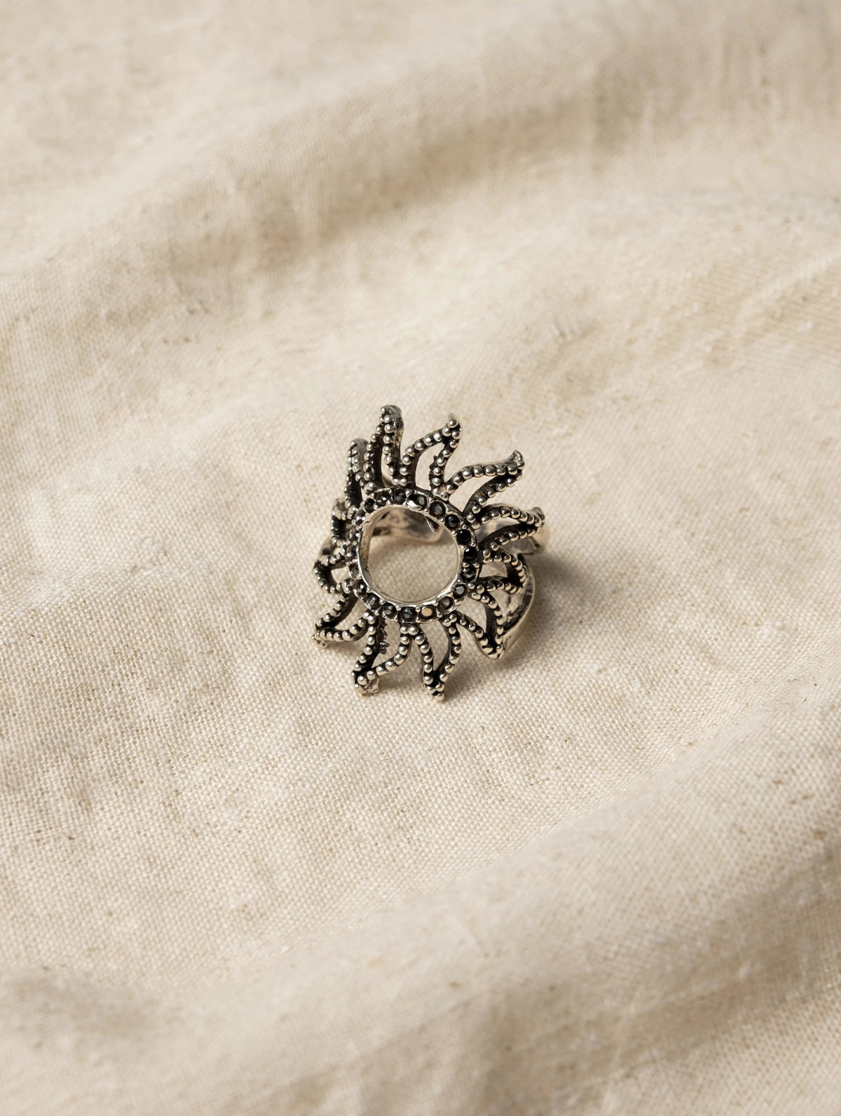 63fe71384f2da238419a4f9e_silver-sunburst-ring-linen-hq_1788986750129.jpeg